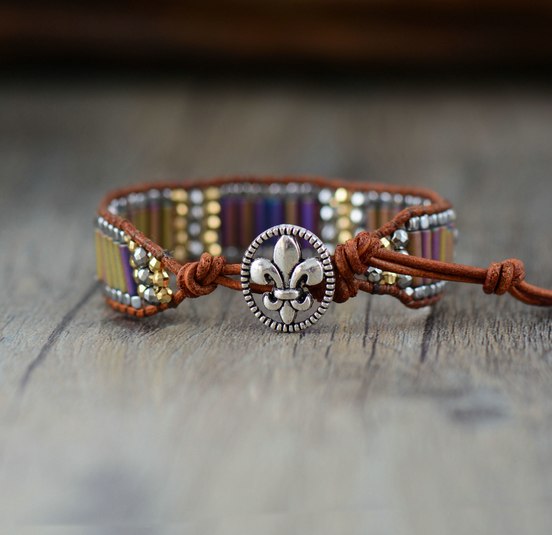 Bracelet with bead details and a decorative clasp on a wooden surface
