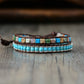 Multistrand bracelet with turquoise beads and stone accents on a wooden surface