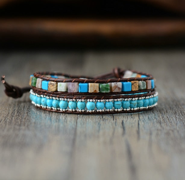 Multistrand bracelet with turquoise beads and stone accents on a wooden surface