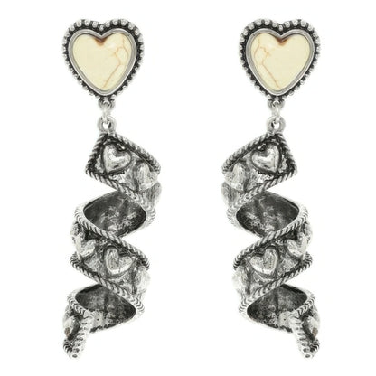 Spiral earrings with heart-shaped gemstones on a white background