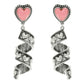 Spiral earrings with pink heart charms on a white background