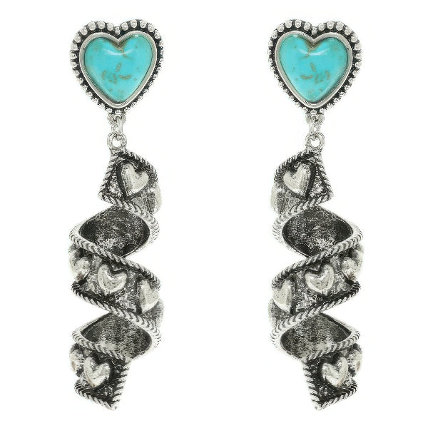 Turquoise heart-shaped earrings with silver spiral designs on a white background