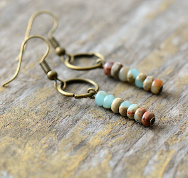 Beaded earrings on a wooden surface