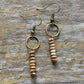 Pair of beaded earrings on a wooden surface