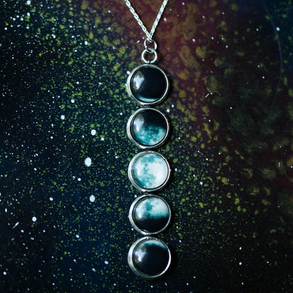 Necklace with five circular stones on a dark, starry background