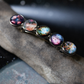 Barrette with galaxy-themed hair clips on a stone surface