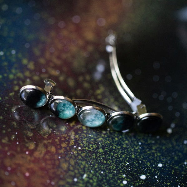 Jewelry set with turquoise stones on a textured surface