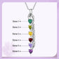 Multicolored gemstone necklace with engraved names on a light purple background