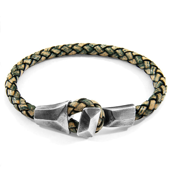 Braided leather bracelet with silver geometric clasp on a white background