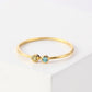Gold ring with two gemstones on a white background
