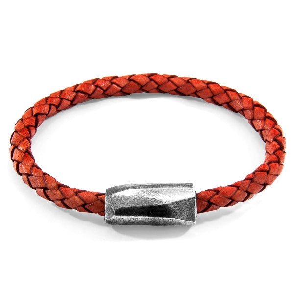 Red braided leather bracelet with a silver clasp on a white background