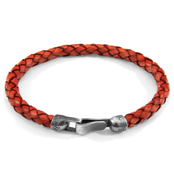 Red braided leather bracelet with a silver clasp on a white background