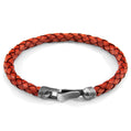 Red braided leather bracelet with a silver clasp on a white background
