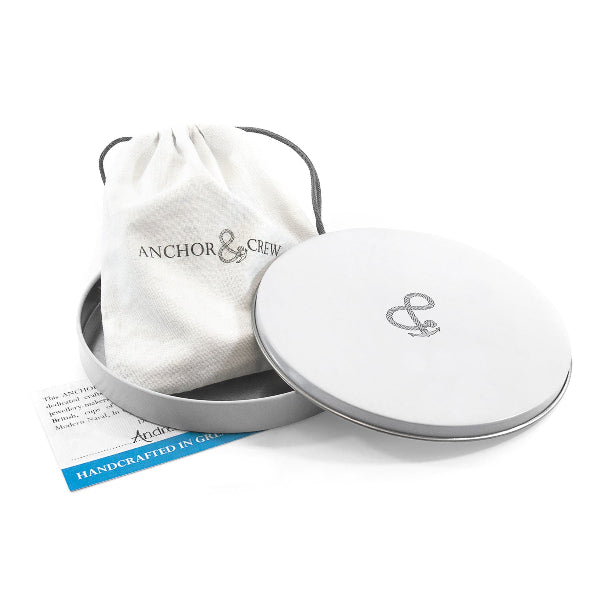 Silver jewelry box with 'Anchor & Crew' logo and matching pouch on a white background