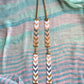 Necklace with chevron pattern on a fabric background