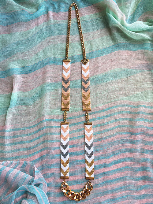 Necklace with chevron pattern on a fabric background