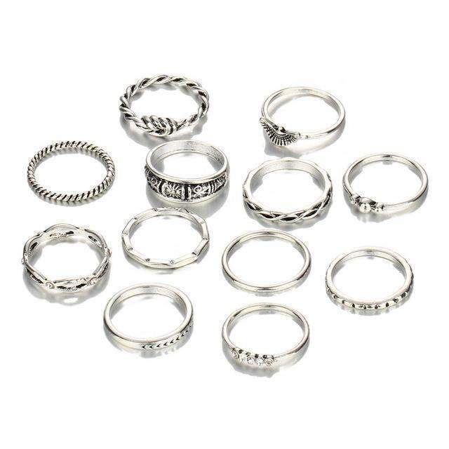 Set of silver rings with various designs on a white background