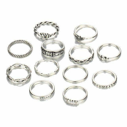 Set of silver rings with various designs on a white background
