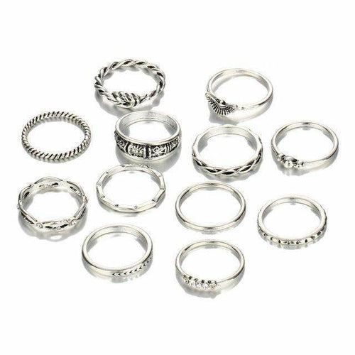 Set of silver rings with various designs on a white background
