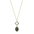 Necklace with a pendant featuring a green stone on a white background