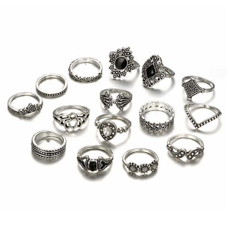 Set of silver rings with black gemstones on a white background