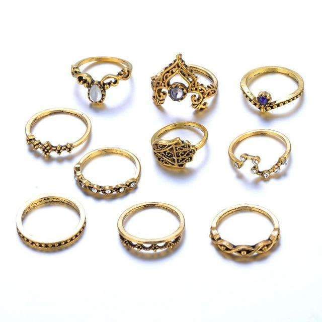 Collection of gold rings with various designs on a white background