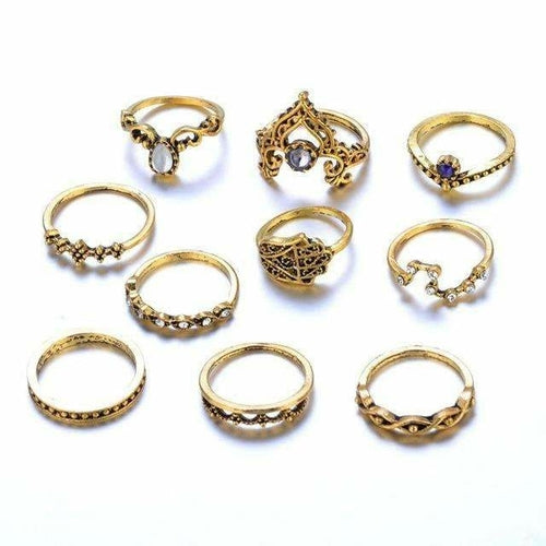 Collection of gold rings with various designs on a white background