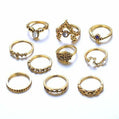 Collection of gold rings with various designs on a white background