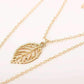 Gold leaf necklace on a white background