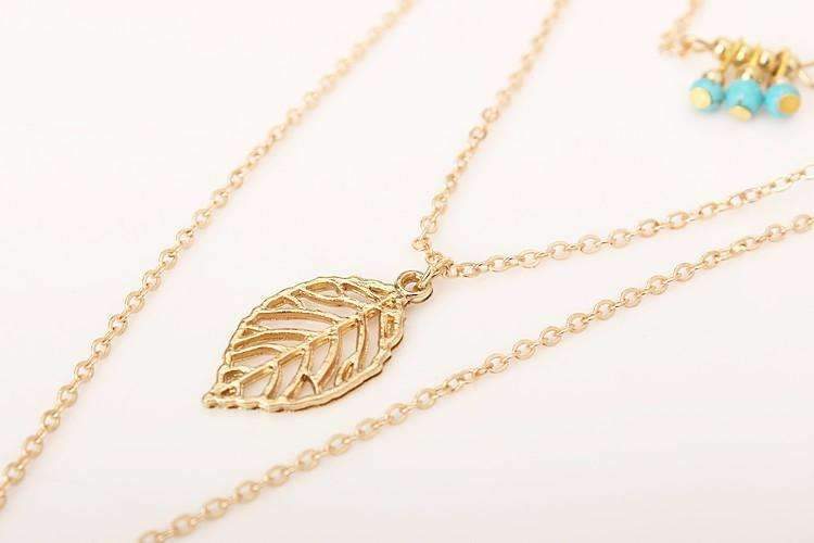 Gold leaf necklace on a white background