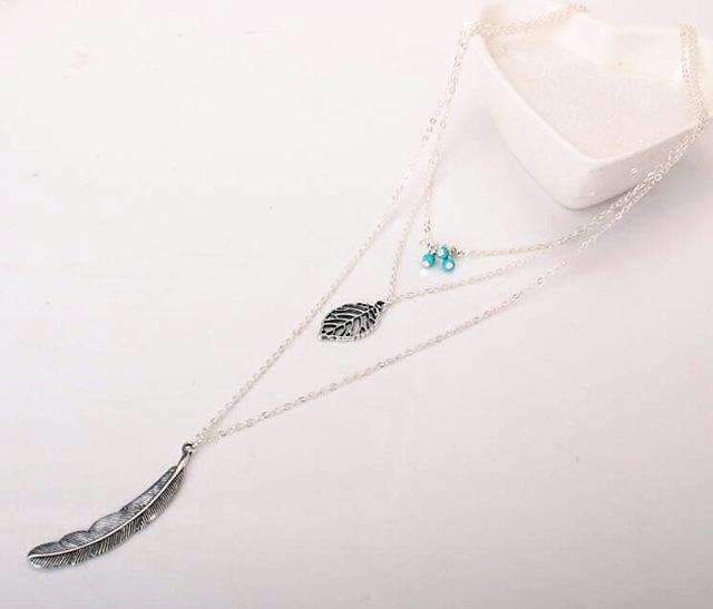 Necklace with feather pendants on a white background