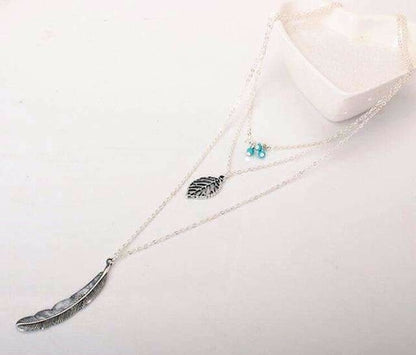 Necklace with feather pendants on a white background