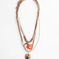 Necklace with layered chains and a pendant on a white background