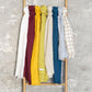Rack with colorful fabric swatches against a textured gray background