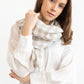 Woman wearing a white outfit with a checkered scarf on a white background