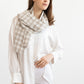 Woman wearing a plaid scarf on a white background