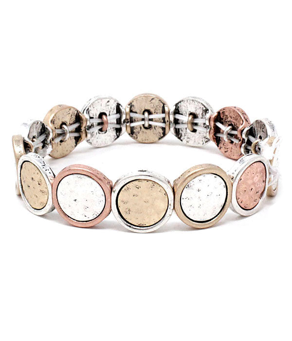 Bracelet with round metallic beads on a white background