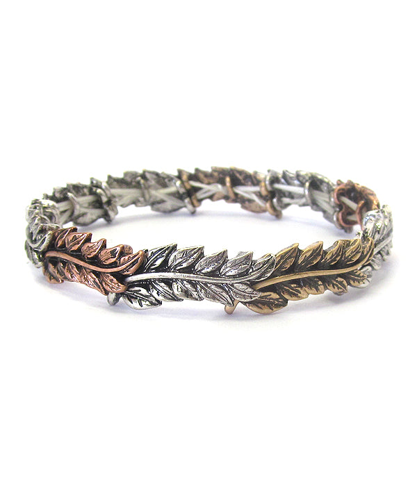 Silver and bronze leaf-patterned bracelet on a white background