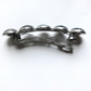 Silver brooch with five round elements on a white background