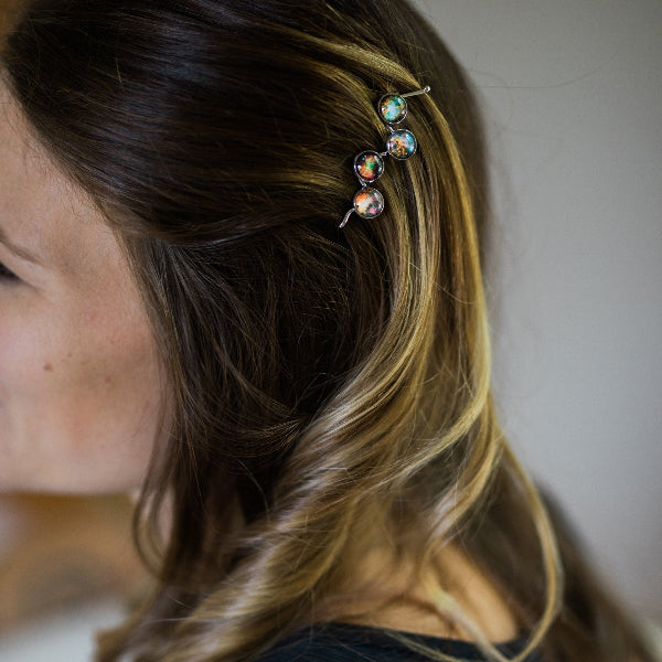 Close-up of a person's hair with a decorative hairpin.