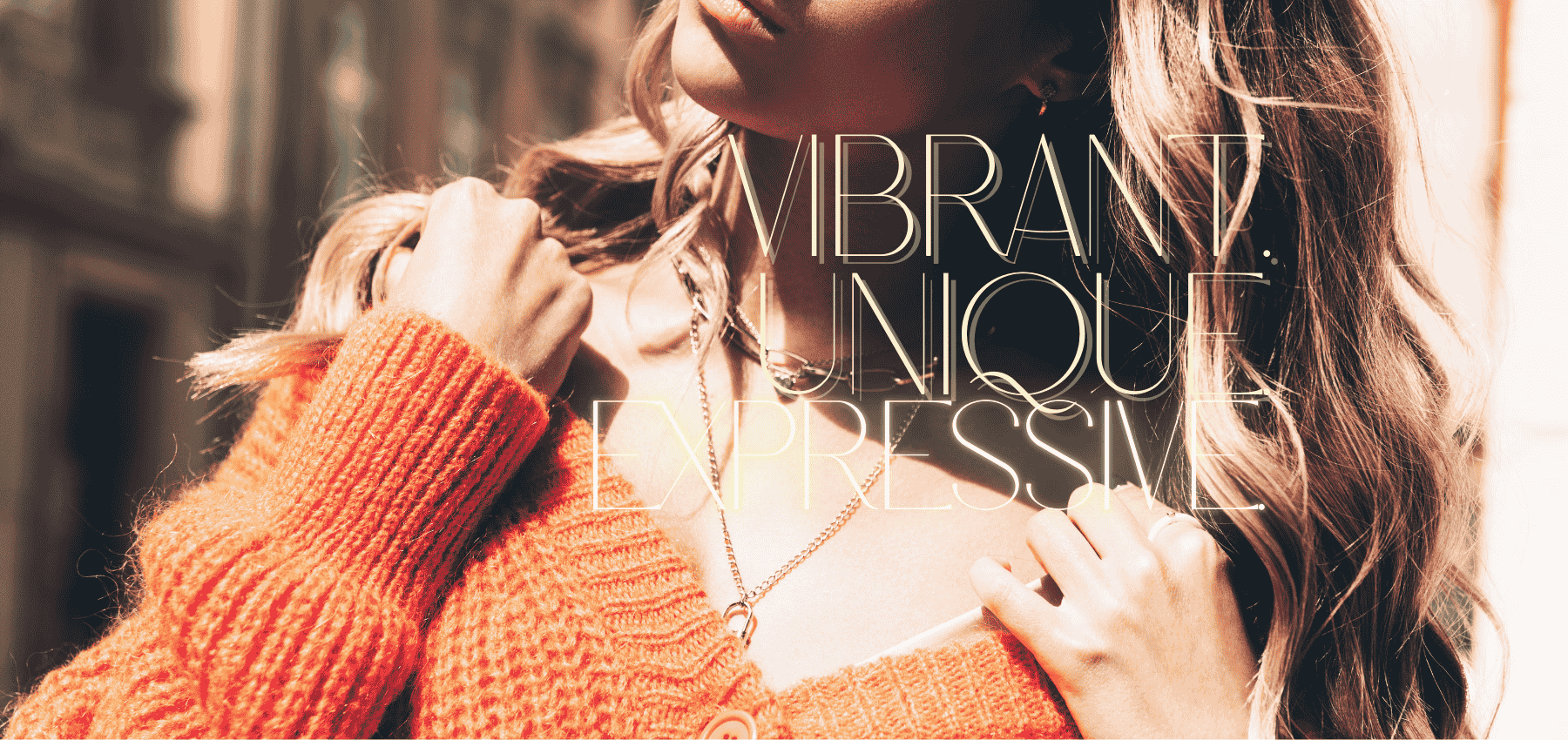Person wearing an orange sweater with text overlay 'Vibrant Unique Essense'.