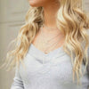 video clip of woman with layered chick triangle necklaces