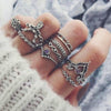 woman's hand with vintage gemstone rings set