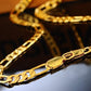 Gold chain on a reflective surface with a blurred background