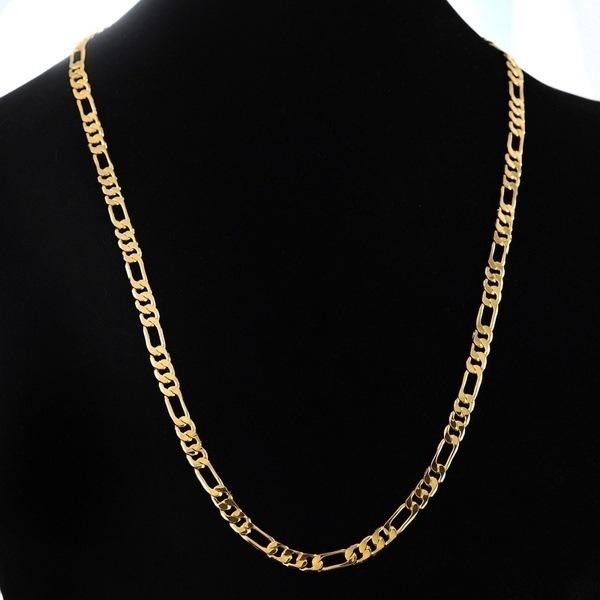 Gold chain necklace on a black mannequin