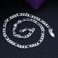 Silver chain necklace on a textured black surface