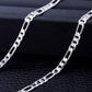 Silver chain necklace on a dark textured surface