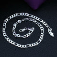 Silver chain necklace on a textured black surface