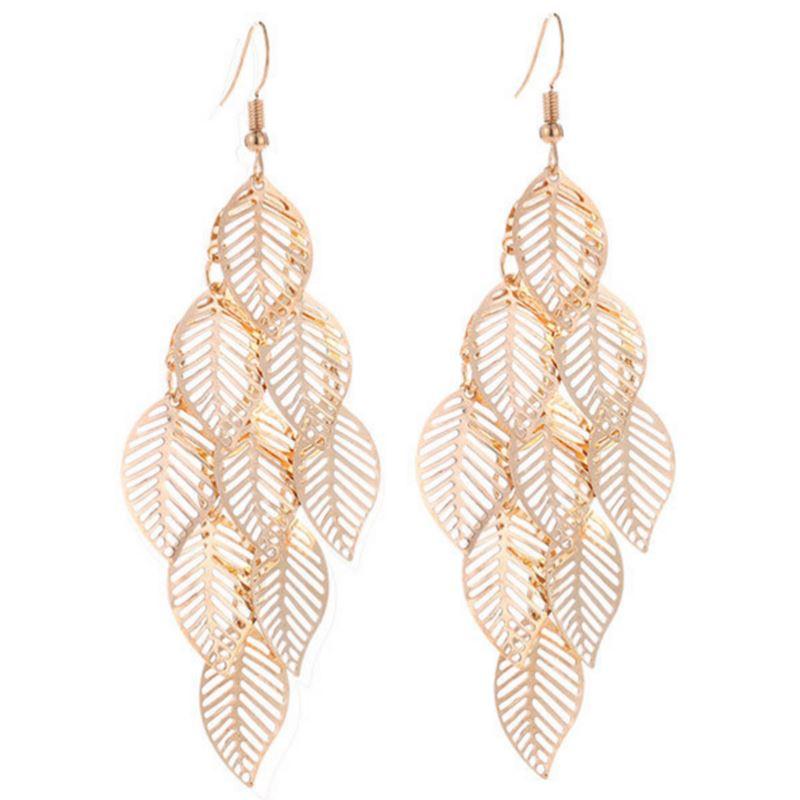 Gold leaf-shaped earrings on a white background