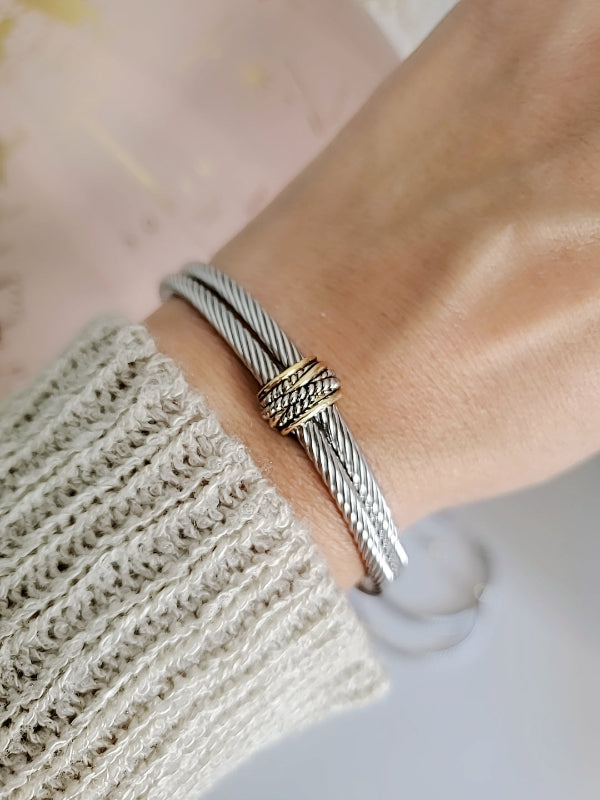 Silver bracelet on a wrist with a blurred background